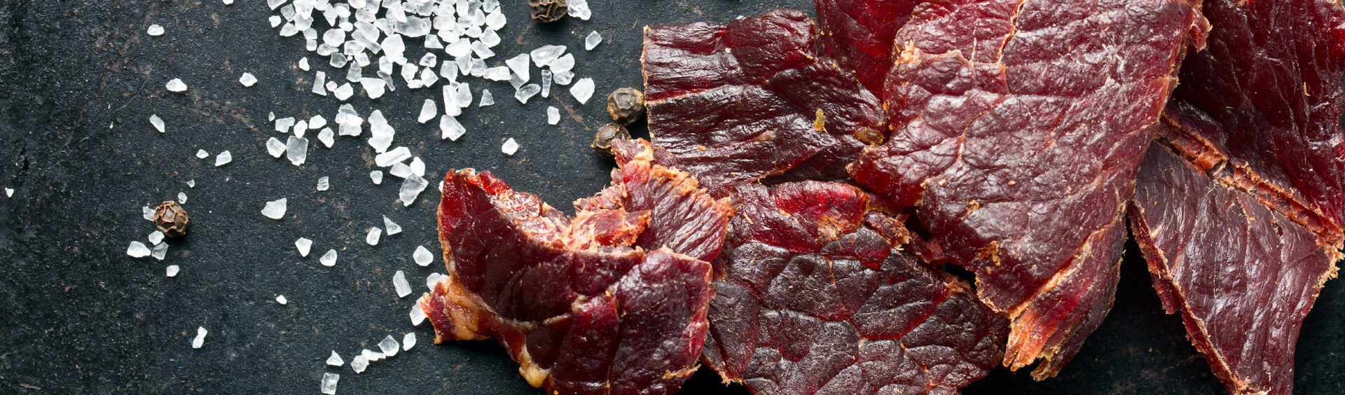 Beef Jerky with Sea Salt on Slate Background