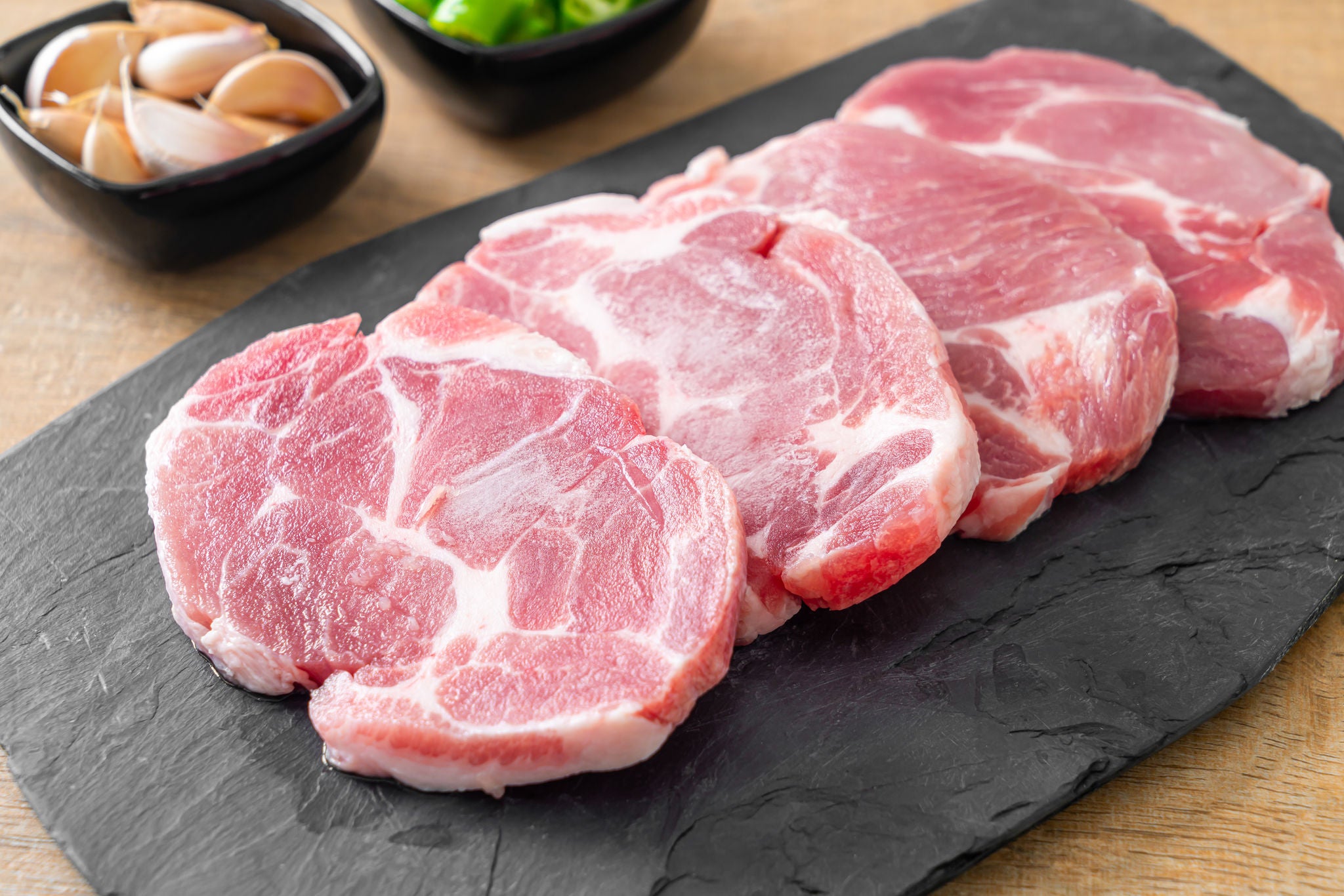 fresh pork neck raw or collar pork on board with ingredients for marinated