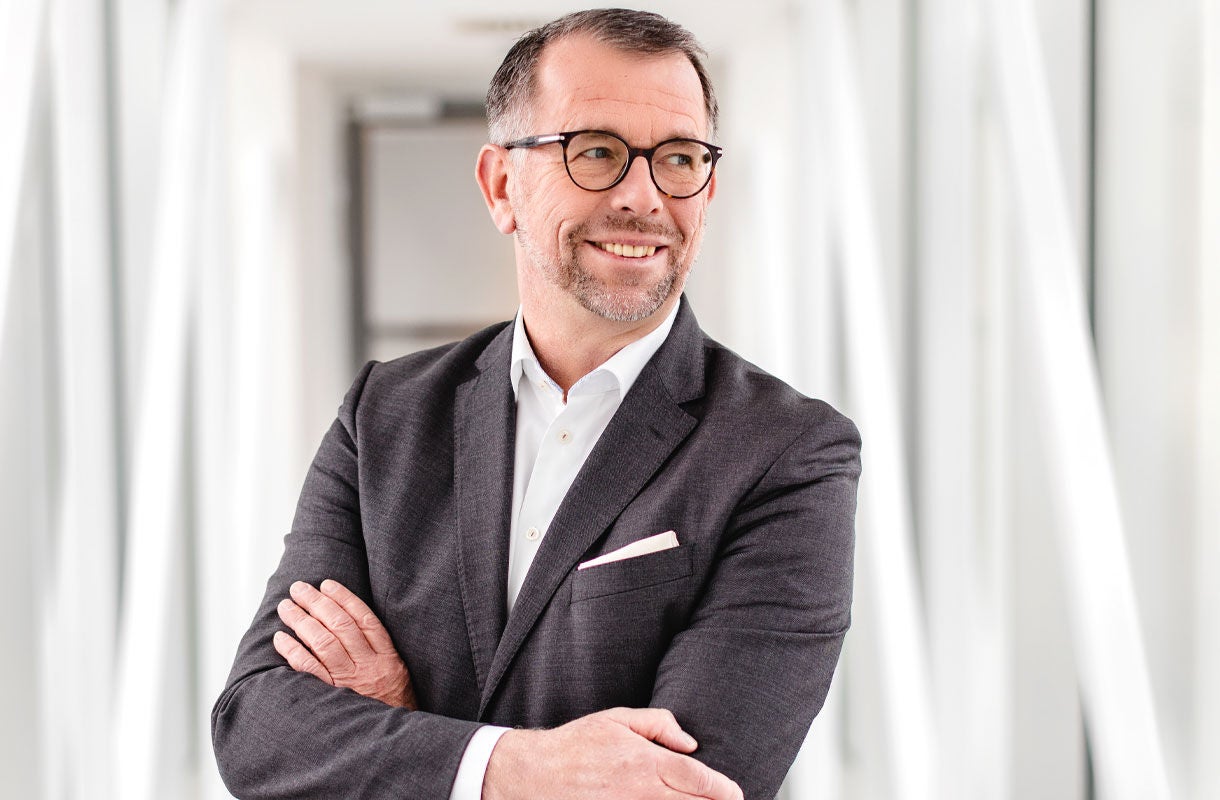 Businessman in Modern Office Corridor